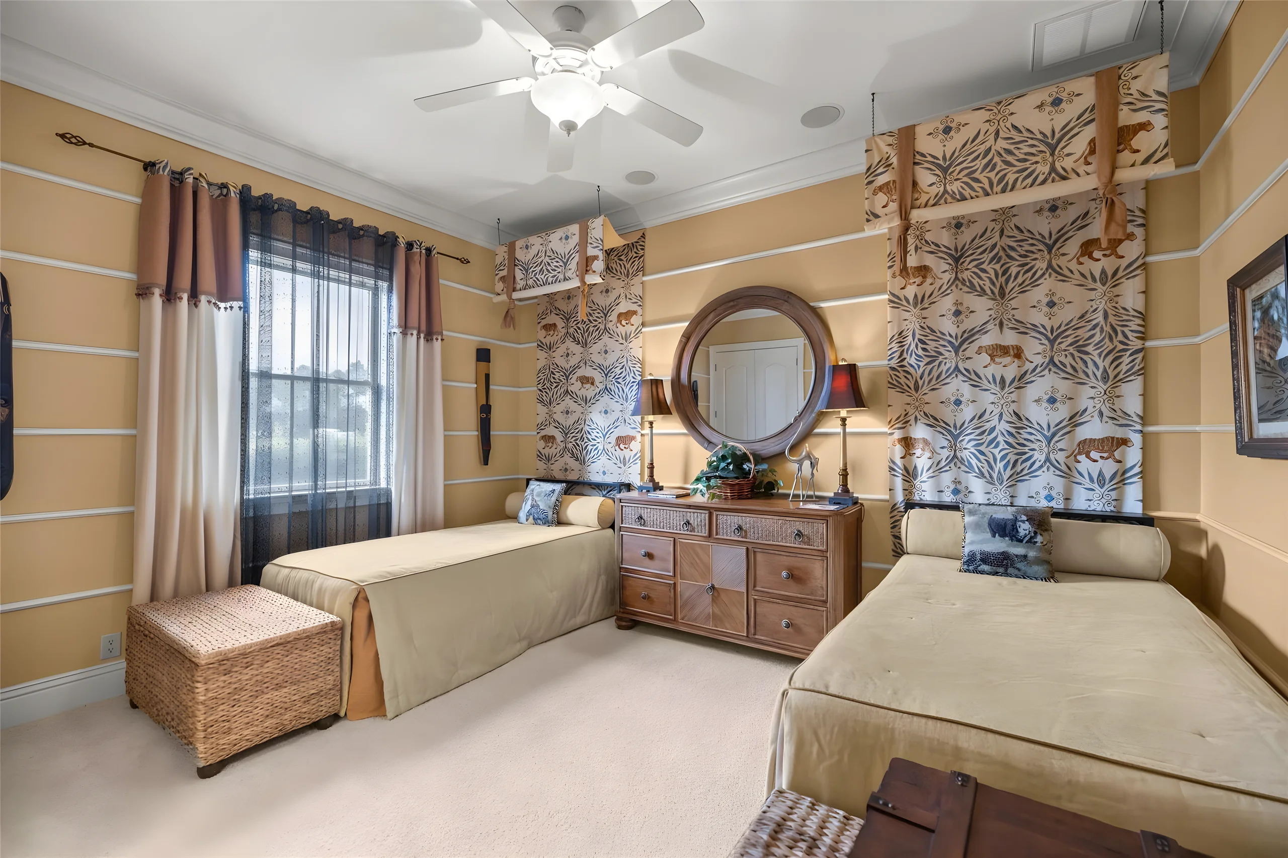 2nd bedroom with two twin beds, a round mirror and a window