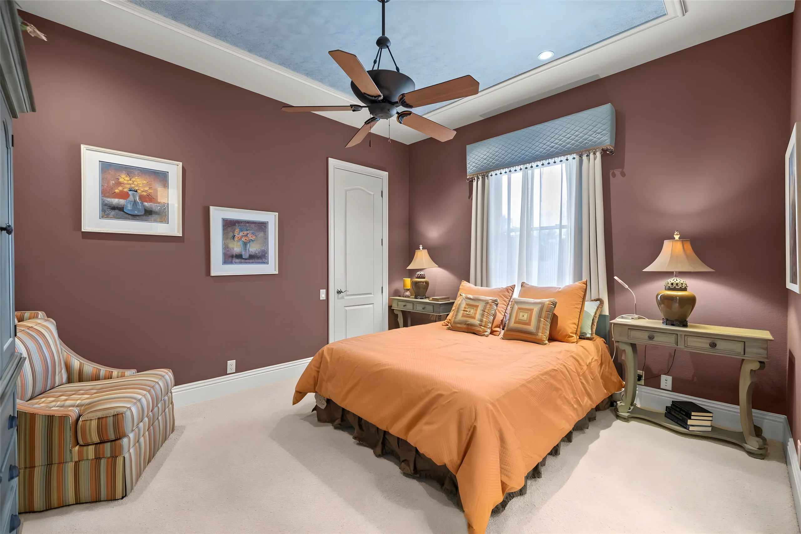 3rd bedroom with a ceiling fan, a reading chair and a window with a valance