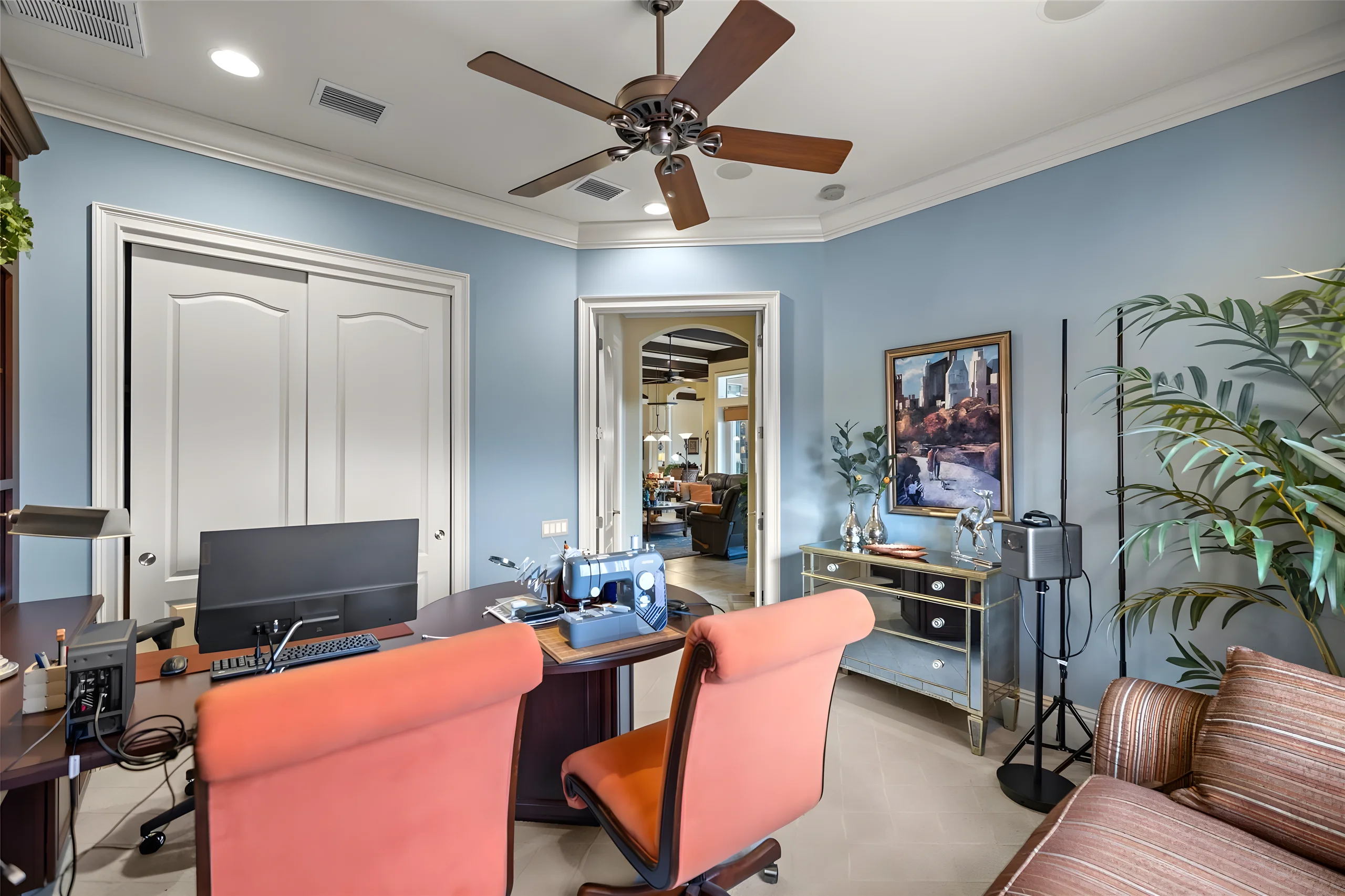 4th bedroom with its double-door closet, blue walls and a desk