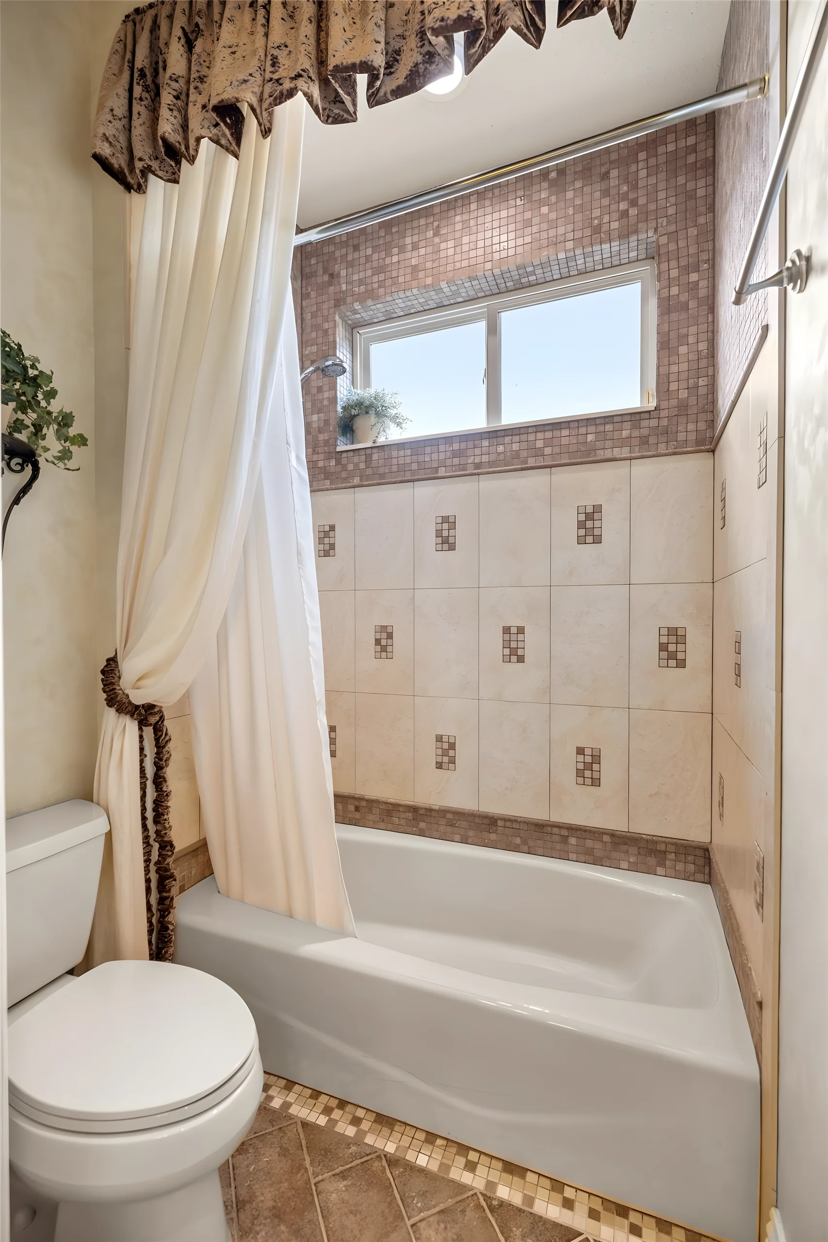 Jack and Jill bathroom tub and shower, with a window above