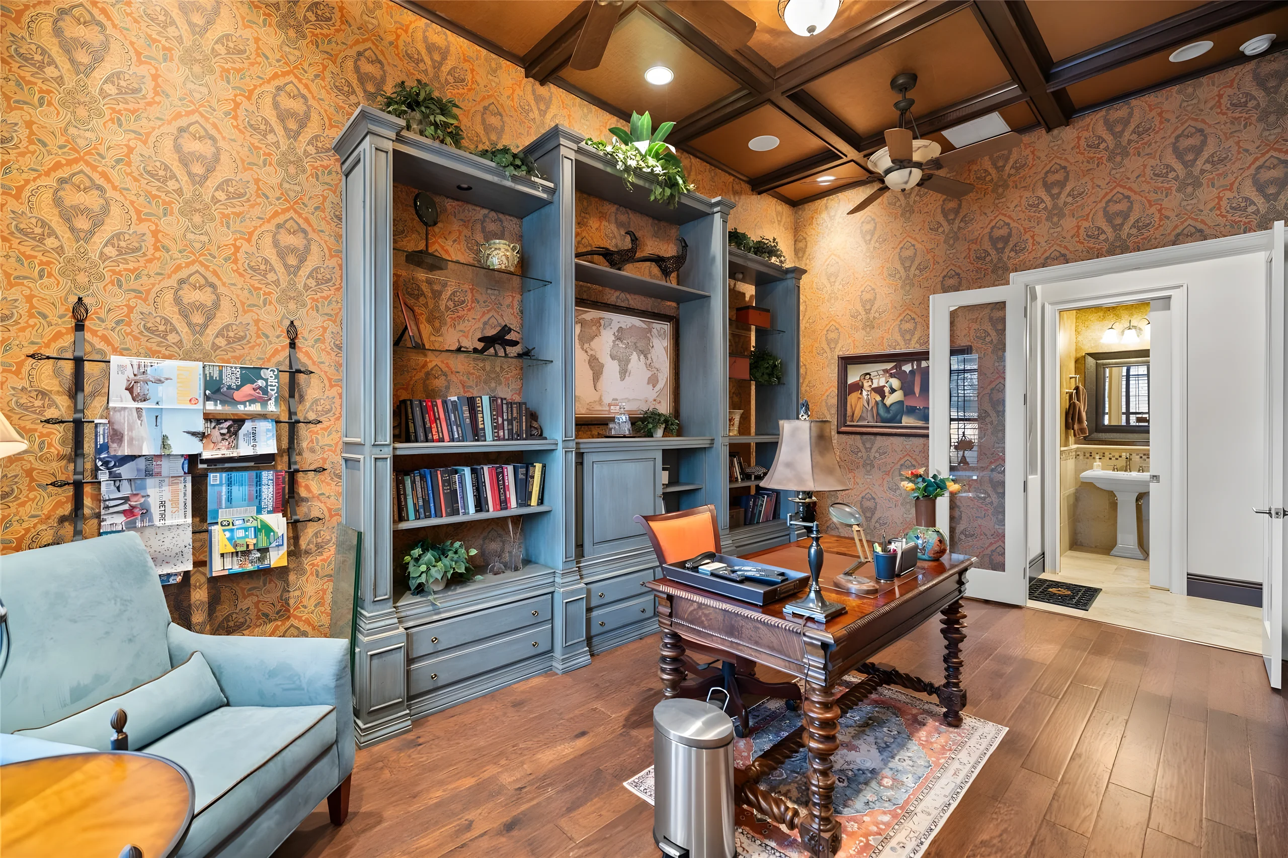 Office with the built-in bookcases, a wood floor and the door to the office bathroom